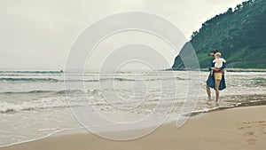 4 k beautifull young girl, mother walking and taking time with her cute little baby, among the Cantabrian coast, in the