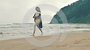 4 k beautifull young girl, mother walking and taking time with her cute little baby, among the Cantabrian coast, in the