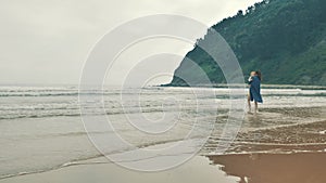 4 k beautifull young girl, mother walking and taking time with her cute little baby, among the Cantabrian coast, in the