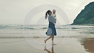 4 k beautifull young girl, mother walking and taking time with her cute little baby, among the Cantabrian coast, in the