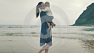 4 k beautifull young girl, mother walking and taking time with her cute little baby, among the Cantabrian coast, in the