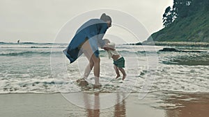 4 k beautifull young girl, mother walking and taking time with her cute little baby, among the Cantabrian coast, in the