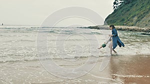 4 k beautifull young girl, mother walking and taking time with her cute little baby, among the Cantabrian coast, in the