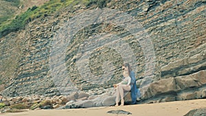 4 k beautifull young girl, mother walking and taking time with her cute little baby, among the Cantabrian coast, in the