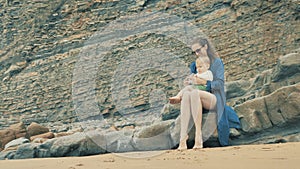 4 k beautifull young girl, mother walking and taking time with her cute little baby, among the Cantabrian coast, in the