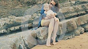 4 k beautifull young girl, mother walking and taking time with her cute little baby, among the Cantabrian coast, in the