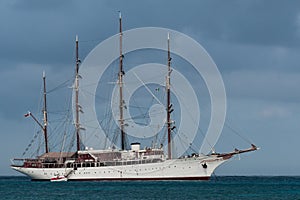 4 mast tall ship anchored with a tender boat in the port of Cozumel, Mexico
