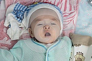 4 Month Asian Chinese baby boy suffering high fever with wet towel on his forehead to relief the temperature
