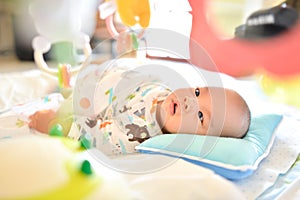 4 Month old Cute little Asian baby playing Playgym