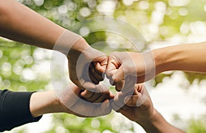4 people join forces, the concept of hand-to-hand to create unity, group of people, hands, teamwork business group by reaching out