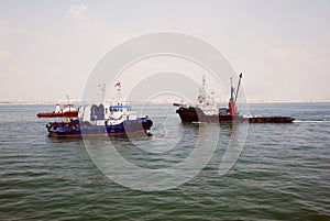 4 tug boats Singapore anchorage.