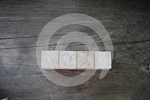 4 Wood Blocks Front View, On Wooden Table, polished wooden table background