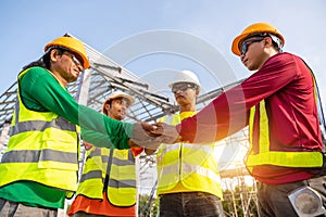 4 Workers in Construction Site, Architect and Engineer construction workers join hands while working at outdoors construction site