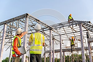 4 Workers in Construction Site, Architect and engineer watching building under construction with workers. Teamwork Concept