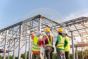 4 Workers in Construction Site, Contractor with workers and Steel roof structure under construction background