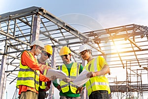 4 Workers in Construction Site, Engineer technician and Architect watching team of Workers Construction concept at Construction