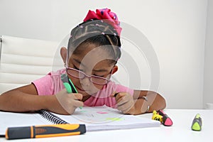 4-year-old brunette Latina girl with autism spectrum disorder ASD like Asperger, Rett and Heller draws at a desk, plays with color