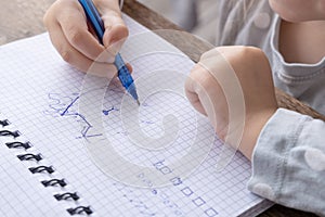4-year-old Child drawing graphic dictation in checkered notebook, Connecting dots into picture, Motor Skill Improvement