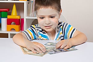 A 4-year-old child learns to count money. Financial literacy and investment education for children