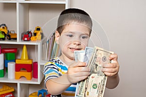 A 4-year-old child learns to count money. Financial literacy and investment education for children