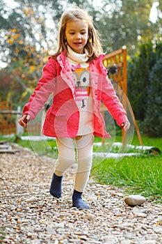 4 year old girl walking over pebbles