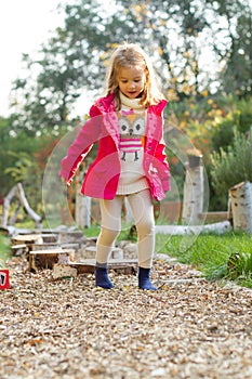 4 year old girl walking over pebbles