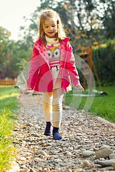 4 year old girl walking over pebbles