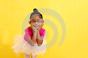 4-year-old Latin brunette girl dressed as a ballerina practices ballet as therapy for autism and ADHD