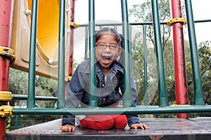 4 year old Latina brunette girl plays in the playground as therapy for Attention Deficit Hyperactivity Disorder ADHD