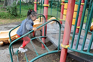 4 year old Latina brunette girl plays in the playground as therapy for Attention Deficit Hyperactivity Disorder ADHD