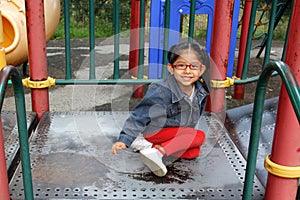 4 year old Latina brunette girl plays in the playground as therapy for Attention Deficit Hyperactivity Disorder ADHD