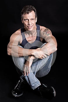 40-50 years old fit man with a vest looking at the camera