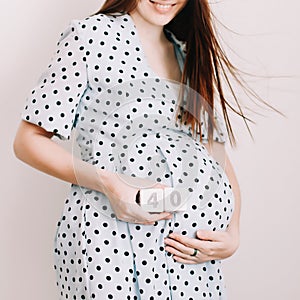 40 weeks of pregnancy. Pregnant woman touching belly. Happy woman pregnancy, maternity, body care. Expecting an upcoming
