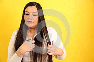 40 year old Latina woman with very long straight hair wants to cut her hair with scissors