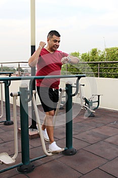 40-year-old Latino man exercises on the roof garden of his apartment building to prevent overweight, diabetes and hypertension