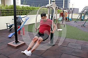 40-year-old man exercises on the roof garden of his building with effort and commitment to lose weight and improve his health