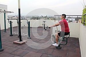 40-year-old man exercises on the roof garden of his building with effort and commitment to lose weight and improve his health