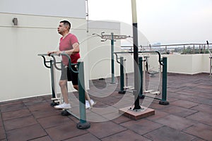 40-year-old man exercises on the roof garden of his building with effort and commitment to lose weight and improve his health