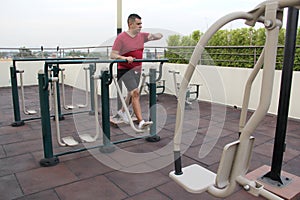 40-year-old man exercises on the roof garden of his building with effort and commitment to lose weight and improve his health