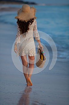 40 year old woman on seashore at sunset walking