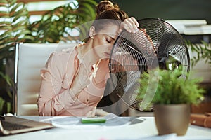 40 years old business woman at work suffer from heat