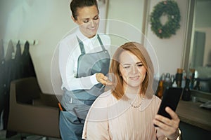 40 years old woman hairdresser in modern beauty studio