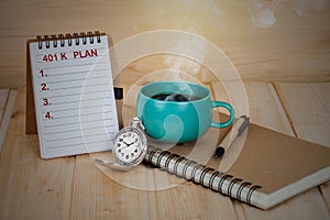 401 K plan list with pocket watch and cup