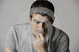 40s to 50s sad and worried man looking frustrated and thoughtful in worried and pensive face expression isolated on grey