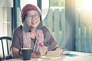 40s years old asian woman relaxing reading and drinking coffee i