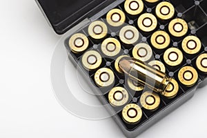 .45 ACP bullet pistol gun with ammunition box on white background