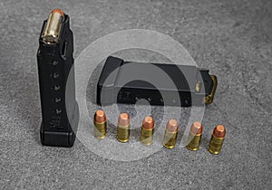 45 caliber hollow point and full metal jacket bullets in magazines and lined up