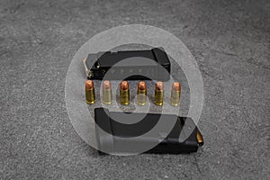 45 caliber hollow point and full metal jacket bullets in magazines and lined up