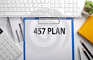457 PLAN written on the paper with keyboard, chart, calculator and notebook