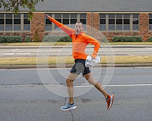 46 year-old Caucasian male leaping into the air playfully after winning his age group in the Turkey Trot 5K in Edmond, Oklahoma.